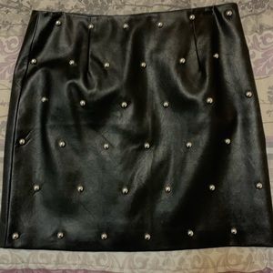 Black faux leather studded mini skirt